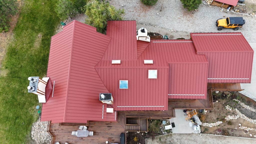 Overhead aerial view of home with Rustic Red standing seam metal roof and multiple skylights